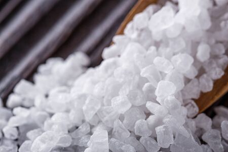 coarse sea salt on dark wooden rustic background.の写真素材