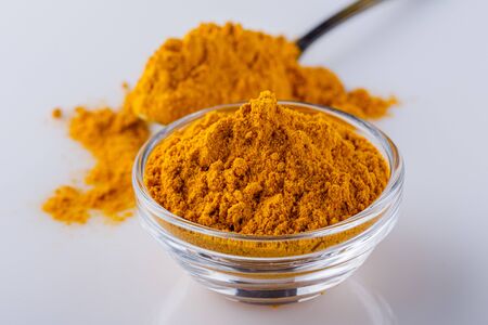natural turmeric powder on white acrylic background.の写真素材