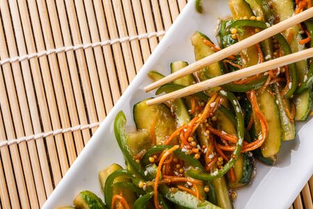 Chinese cucumbers on bamboo mat on rustic background.の写真素材