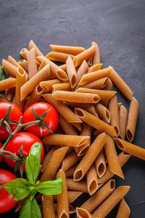 concept of traditional italian pasta with tomatoes and basil.の写真素材