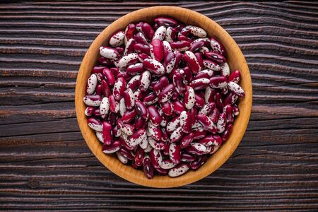 Fresh organic natural beans on wooden rustic background.