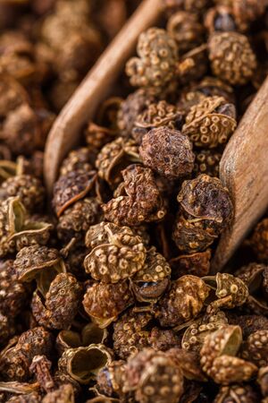 fragrant Sichuan pepper on white acrylic background.