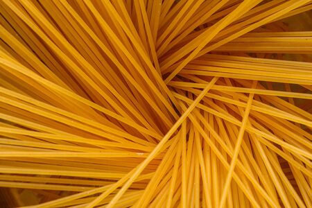 traditional italian pasta in a metal pan on a wooden background.の写真素材