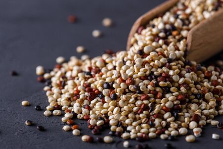 mix of quinoa grains on a dark stone background.の写真素材