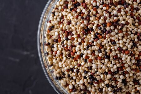 mix of quinoa grains on a dark stone background.の写真素材
