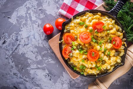 delicious pasta and cheese casserole in a cast iron skillet.の写真素材