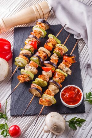 chicken kebabs with vegetables and mushrooms on a rustic background.の写真素材