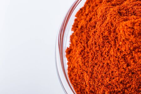 fragrant ground paprika on a white acrylic background.の写真素材