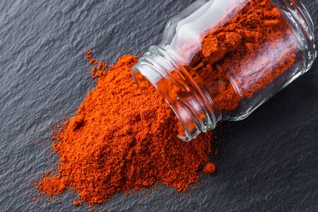 aromatic ground paprika on a dark stone background.の写真素材