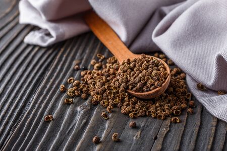 Sichuan pepper on a dark wooden rustic background.の写真素材