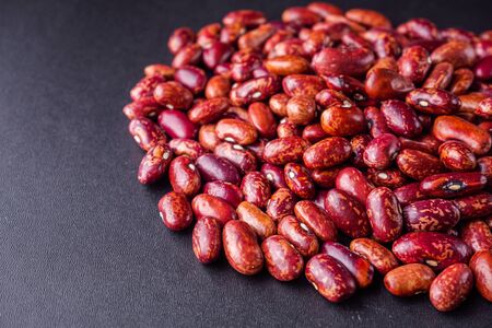 fresh organic natural beans on black background.の写真素材