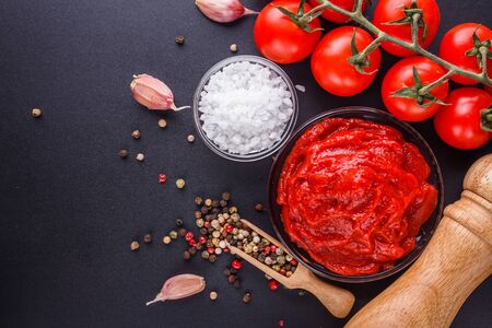 fresh natural tomato paste on black background.の写真素材