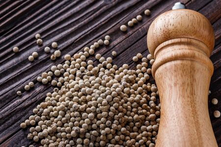 white peppercorns in wooden scoop on rustic background.の写真素材