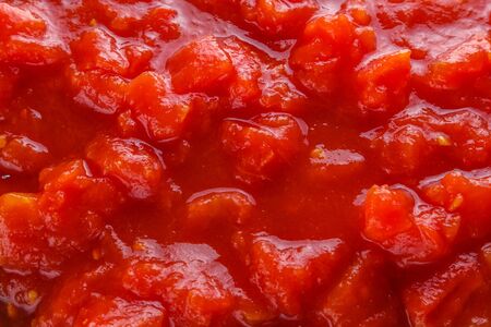 juicy canned tomatoes on wooden rustic background.の写真素材