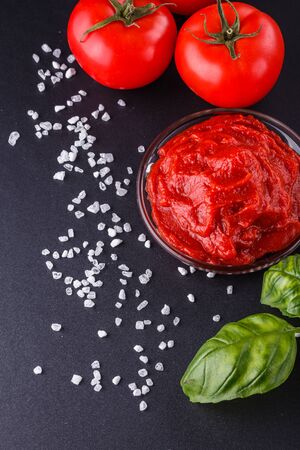 fresh natural tomato paste on black background.の写真素材