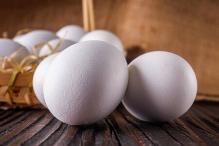 white chicken eggs on wooden rustic background.の写真素材