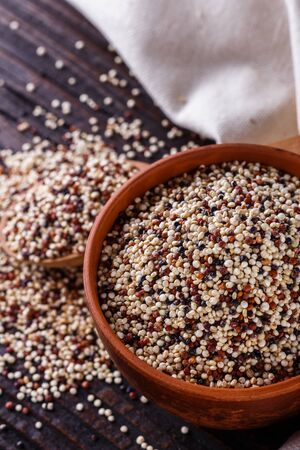 mix of quinoa grains on dark wooden rustic background.の写真素材