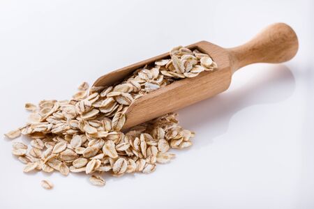 raw oat flakes on white acrylic background.の写真素材