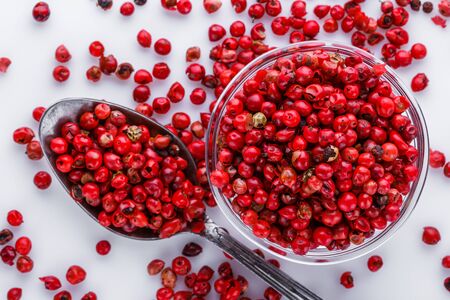 fragrant pink peppercorns on white acrylic background.の写真素材