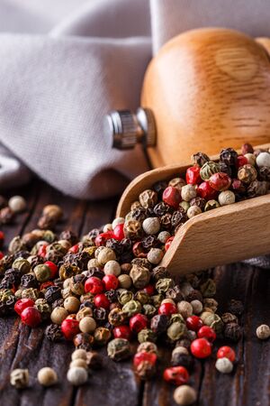 mix of peppercorns on a dark wooden rustic background.の写真素材