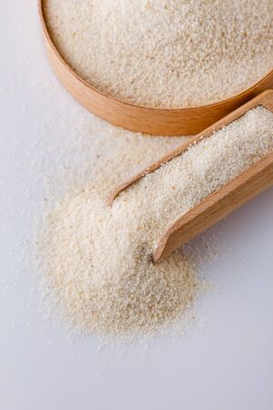 natural organic semolina on white acrylic background.の写真素材