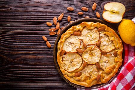 crispy apple galette with almonds on rustic wooden background.の写真素材