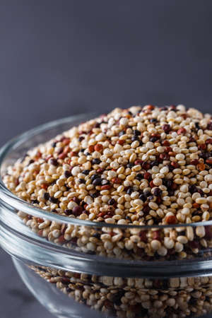 mix of quinoa grains on a dark stone background.の写真素材
