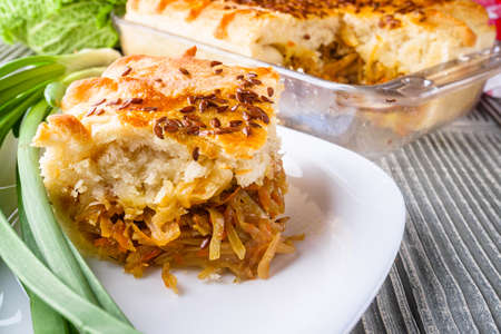 freshly baked cabbage pie on rustic wooden backgroundの写真素材