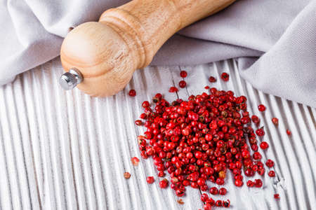 pink peppercorns on white wooden rustic background.の写真素材