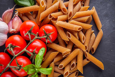 concept of traditional italian pasta with tomatoes and basil.の写真素材