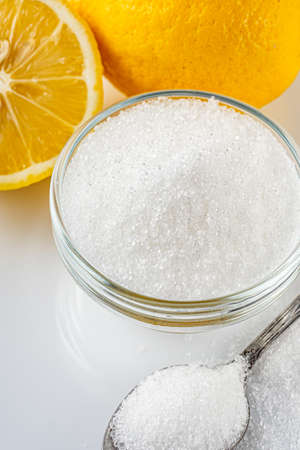 citric acid on a white acrylic background.
