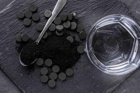 activated carbon on a dark stone background.の写真素材