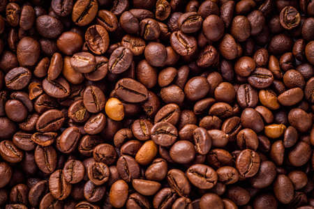aromatic fresh coffee beans on a white wooden rustic background.の写真素材