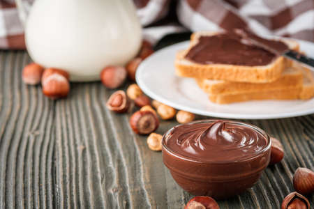 toasts with chocolate butter on a dark wooden rustic background.