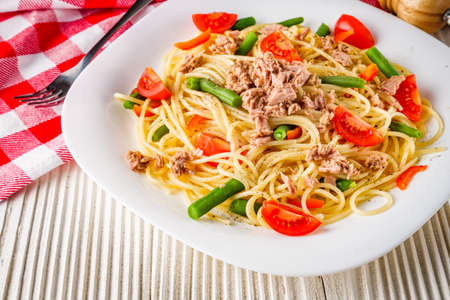 delicious traditional Italian pasta with tuna on a white rustic wooden background.の写真素材