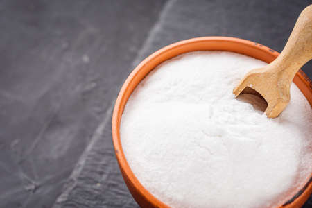 baking soda powder on a dark stone background.の写真素材