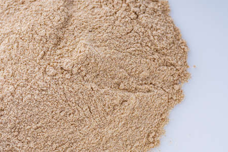 fresh natural buckwheat flour on a white acrylic background.