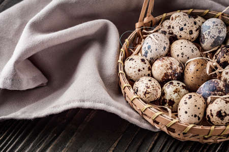 fresh quail eggs on a dark wooden rustic background.の写真素材