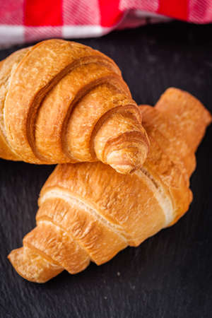 delicious fresh croissant on a white wooden rustic background.の写真素材