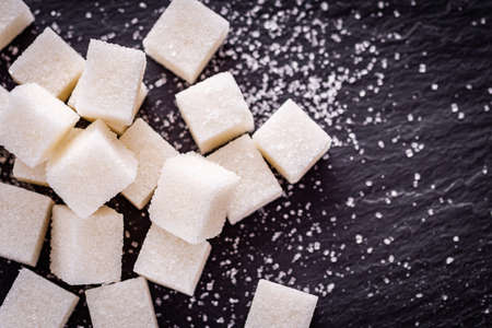 sugar refined on a dark stone background.