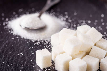 sugar refined on a dark stone background.