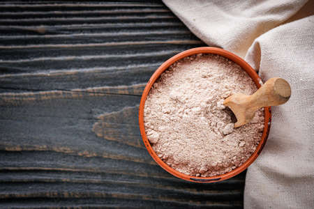 fresh natural buckwheat flour on a dark wooden rustic background culinary concept.の写真素材