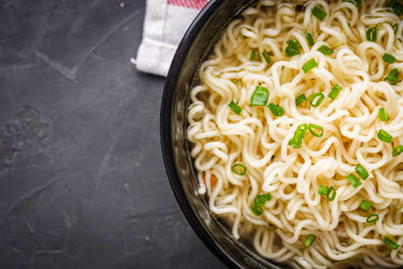 instant egg noodles on a dark stone background.の写真素材