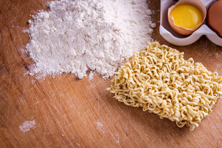 instant egg noodles on a wooden rustic background.の写真素材