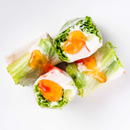 appetizing spring rolls with sea food and philadelphia cheese on a white background.