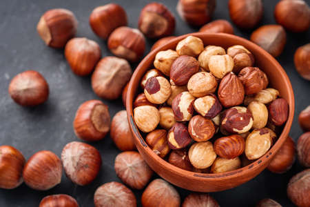fresh natural hazelnuts on a dark stone background.の写真素材