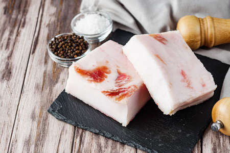 piece of lard on a wooden rustic background.の写真素材