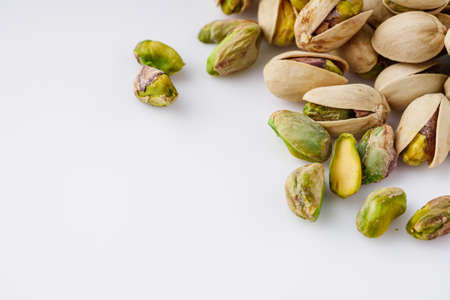 fresh salted pistachios on a white background.