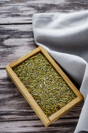 fragrant dried rosemary on a wooden rustic background.