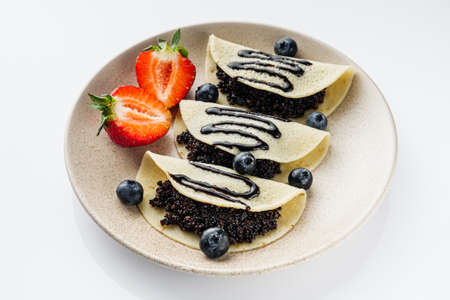 sweet dessert pancakes with quinoa on a white background.の写真素材